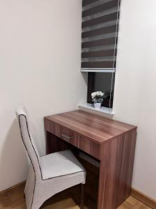 a wooden desk with a chair and a window at Apartments Divanhana 2 in Kiseljak