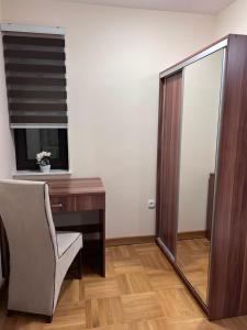 a room with a desk and a chair and a mirror at Apartments Divanhana 2 in Kiseljak