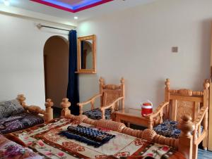 a living room with two chairs and a couch at Nambal Hotel, Kalam in Kalām