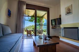 a living room with a couch and a table at Chara House in Skoutari