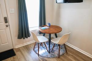 a small table with two chairs and a book on it at Cozy Studio - Walk to the Beach! in Jacksonville Beach