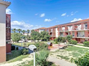a view of an apartment complex with a courtyard at 3284 - appartement 4 couchages avec piscine in Argelès-sur-Mer