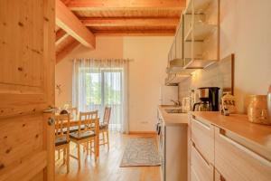 a kitchen and dining room with a table and chairs at Haus Emanuel in Weilerbach