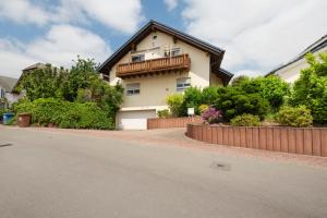 a house on a street with a fence at Haus Emanuel in Weilerbach