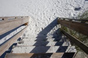 a stairway leading up to a sandy beach at Cozy Studio - Walk to the Beach! in Jacksonville Beach +1 photo