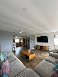 a living room with two couches and a coffee table at Wheal Frances-Beautifully Fitted Bungalow Helston Cornwall in Helston