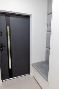 a sliding glass door in a room with a window at Apartament Ponidzie in Zbludowice