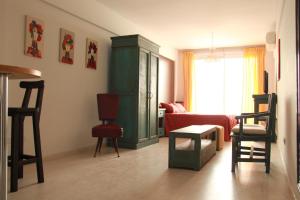 a living room with a red couch and a green cabinet at Miliño Apart Hotel in Buenos Aires +23 photos