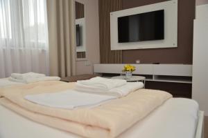 Postel nebo postele na pokoji v ubytování Apartmani Tomić