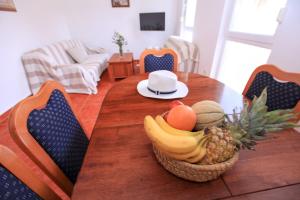 a dining room table with a basket of fruit on it at AG Komarna - Peljesac Bridge Apartments in Komarna
