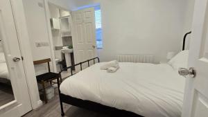 a bedroom with a bed with a stuffed animal on it at Central & Stylish, Two Bed, Two Bath in Galway