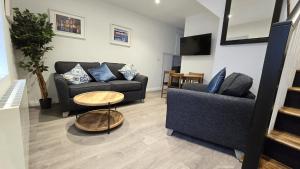 a living room with two couches and a table at Central & Stylish, Two Bed, Two Bath in Galway