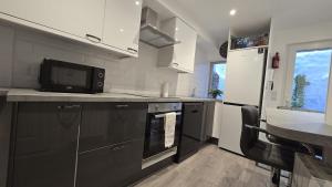a kitchen with a microwave oven and a refrigerator at Central & Stylish, Two Bed, Two Bath in Galway +7 photos