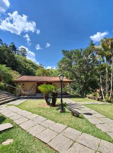a park with a bench in front of a building at Pousada Araucária in São Luiz do Paraitinga