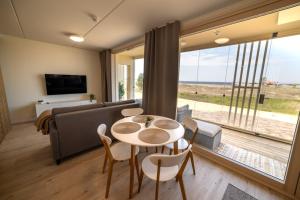 un salon avec une table, des chaises et un canapé dans l'établissement Marina Resort C1, à Kalajoki