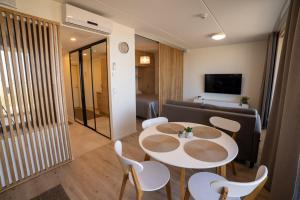 une pièce avec une table, des chaises et un canapé dans l'établissement Marina Resort C1, à Kalajoki 2 autres photos
