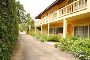 a house with a walkway next to a building at Moonrisevillas in Negril