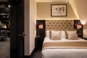 a bedroom with a large bed with a large headboard at The Vermont Hotel & Vermont Aparthotel in Newcastle upon Tyne