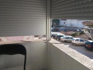 a view of a parking lot with cars parked at STIP Centar Private Room in Novo Selo
