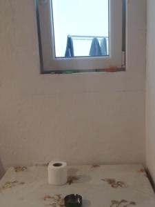 a bathroom with a roll of toilet paper on a table at STIP Centar Private Room in Novo Selo