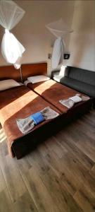 two beds in a room with two lamps on top at Angelos aparts in Arillas