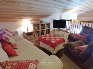 a living room with a couch and a tv at Charmant appart. 70m², 2 chambres, mezzanine, balcon sud, garage, près commerces, navettes - FR-1-458-110 in Le Grand-Bornand
