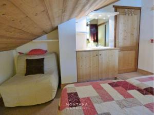 a bedroom with a bed and a sink in a room at Charmant appart. 70m², 2 chambres, mezzanine, balcon sud, garage, près commerces, navettes - FR-1-458-110 in Le Grand-Bornand