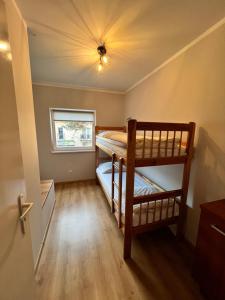 two bunk beds in a room with a ceiling at OW LIWIA w Niechorzu in Niechorze