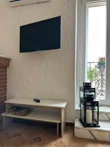 a living room with a tv hanging on the wall at La Casetta in Ordona