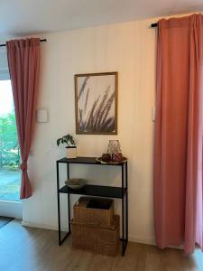 a table in a room with curtains and a window at Idylle am Berliner Stadtrand in Schönefeld +1 photo