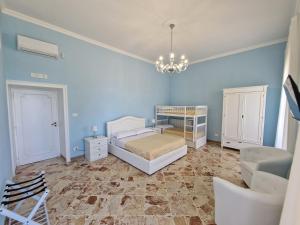 a blue bedroom with a bed and a crib at VILLA ESMERALDA in Salerno +35 photos