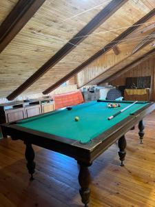 a pool table in the middle of a room at Salako svečių namai in Salakas