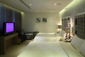 เตียงในห้องที่ Hsiangkelira Hotel