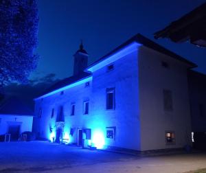 a white building with lights on it at night at Grad Tuštanj in Moravče