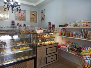 a bakery with a display case filled with lots of food at MARGARITAS' ROOMS in Agios Gordios