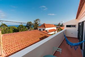 a view from the balcony of a house with a hammock at GuestReady - Aragão Guest house in Funchal