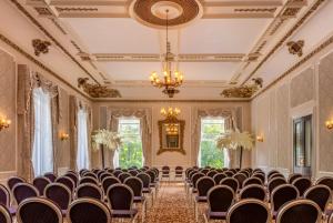 an empty room with chairs and a chandelier at The Palace Hotel Buxton & Spa in Buxton