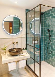 a bathroom with a sink and a glass shower at The Chancery Hotel in Dublin