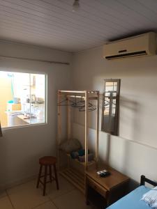 a bedroom with a bed and a window and a shelf at Apto 4 ótimo local próximo shopping in Campo Grande