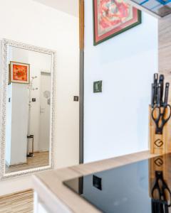 a mirror over a sink in a bathroom at Apartments&Rooms Villa Rudi in Bibinje