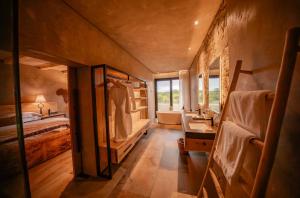 a large bathroom with a bed and a sink at Kapama River Lodge in Kapama Private Game Reserve