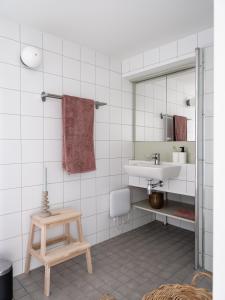 a bathroom with a sink and a mirror at Waterfront Cabins in Gothenburg