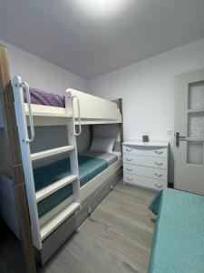 a small room with a bunk bed and a dresser at nemo's house in Mesimvría