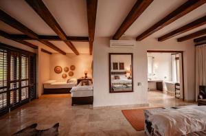 a bedroom with two beds and a mirror at Kapama River Lodge in Kapama Private Game Reserve