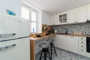 a kitchen with white cabinets and a counter at Duplex apartment Domi in Slatine +39 photos