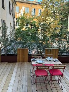 a table and chairs on a patio with a view at Les Suites du Cours & Spa in Aix-en-Provence