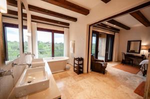 a large bathroom with a tub and a sink at Kapama River Lodge in Kapama Private Game Reserve