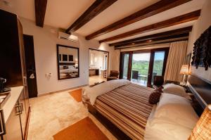 a bedroom with a bed and a large window at Kapama River Lodge in Kapama Private Game Reserve