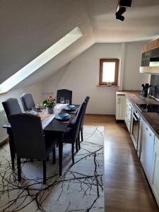 a dining room with a table and chairs in a kitchen at 75qm Apartment in Burgstaedt +14 photos