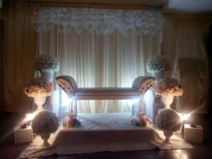 a room with a bed with flowers and lights at Hotel Sri Garden Sdn. Bhd. in Kangar